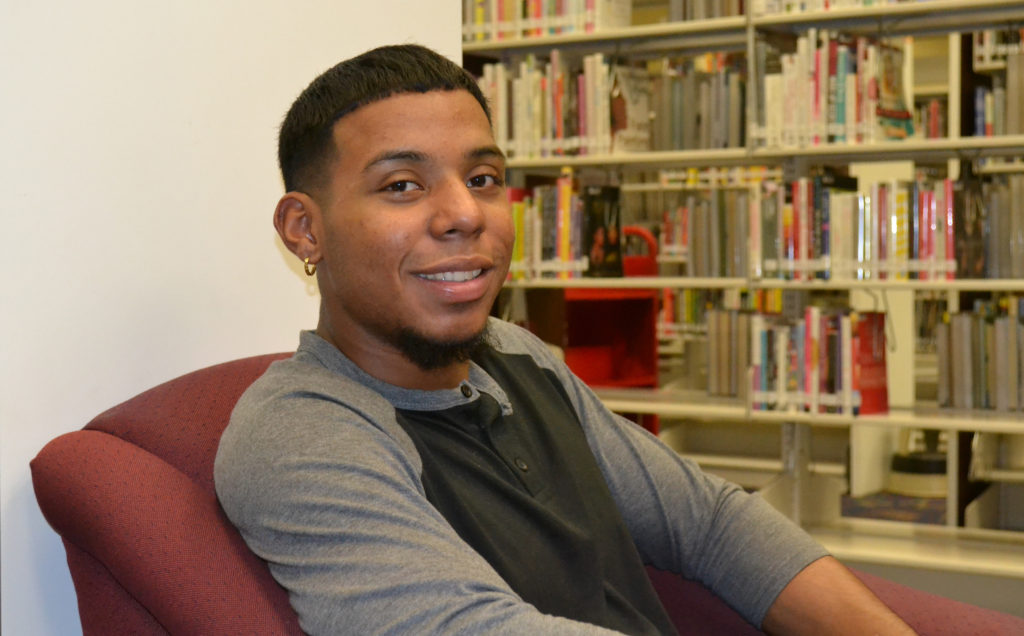 Gabriel Flowers sitting in library