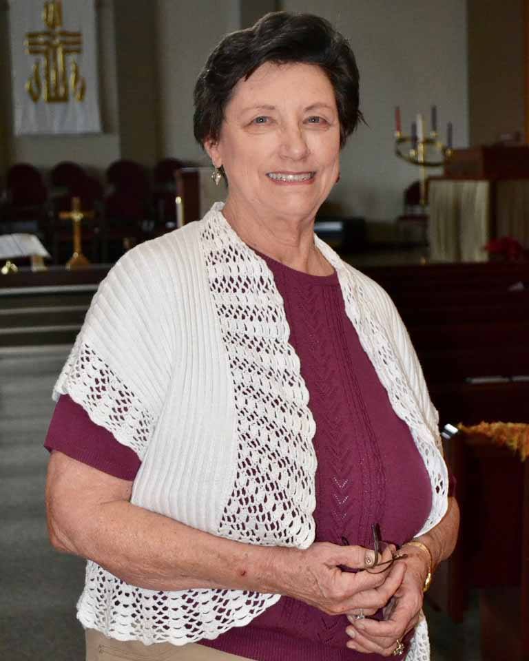 Barbara Wilson stands in her church's sanctuary