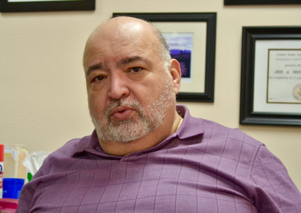 Joe Montemayor sits in his office