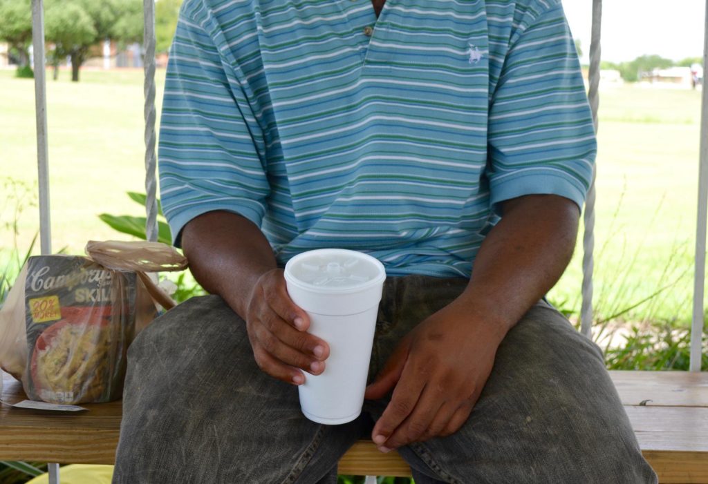 Lee holds a cup