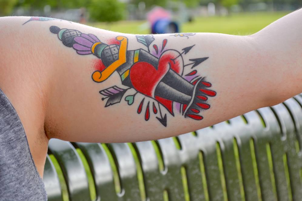 Heart tattoo on young woman's arm