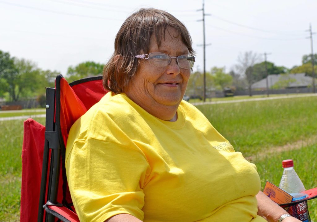 Holly Miller sits in a chair outside