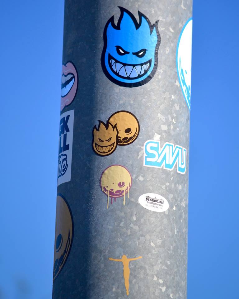 Logo stickers on a poll at the park