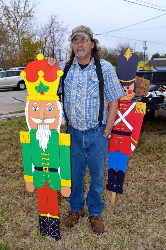 Man stands next to woodworking project