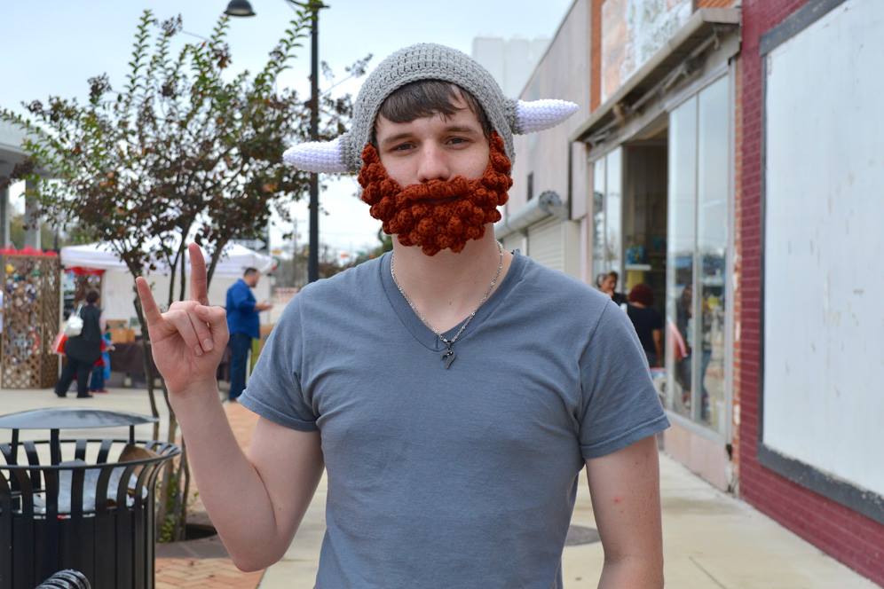 Young man wears fake Viking beard and hat