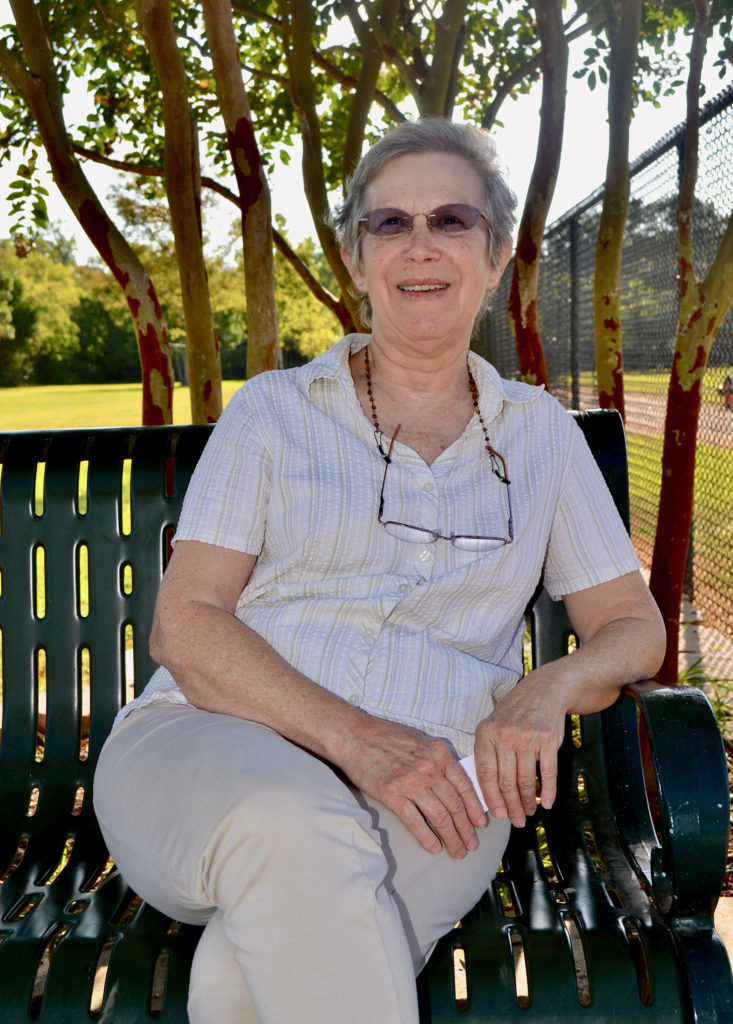 Woman sits on bench at park