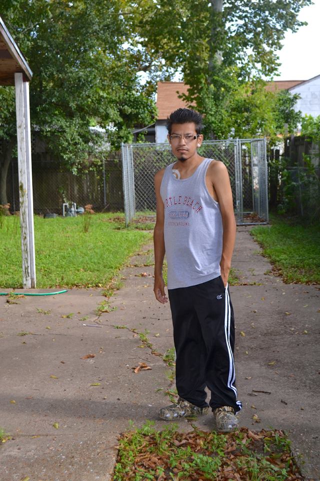 Young man stands in driveway