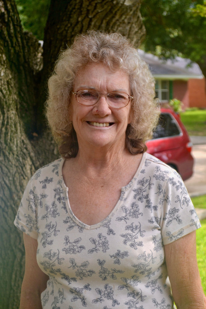Woman stands near tree