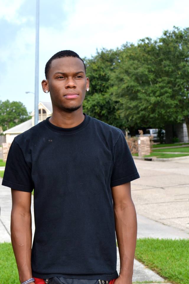 Young man stands in his driveway
