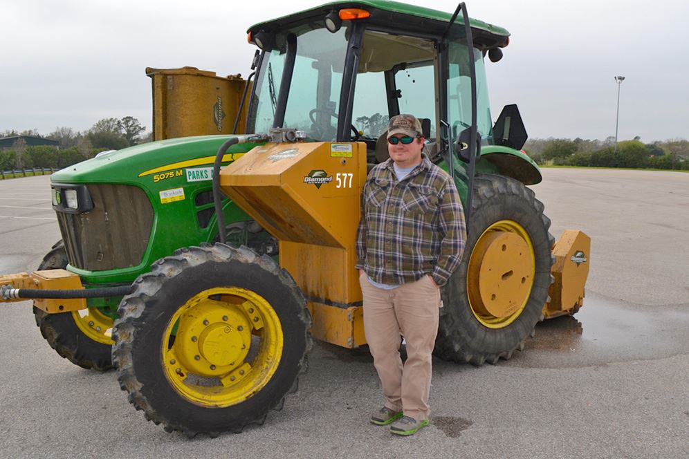 Hunting guide stands near tractor