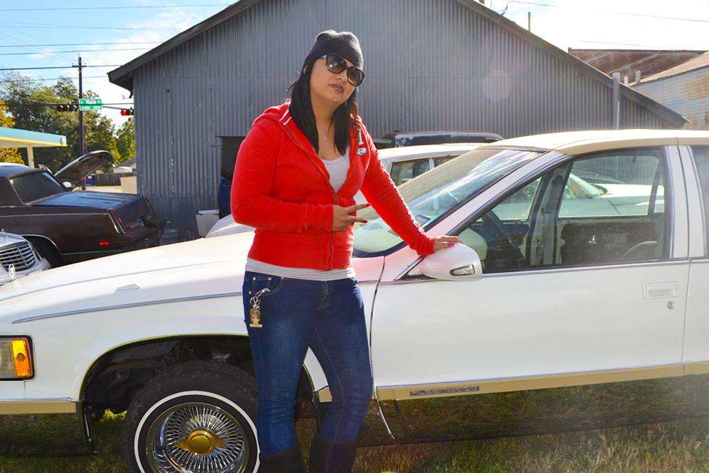 Woman stands next to car