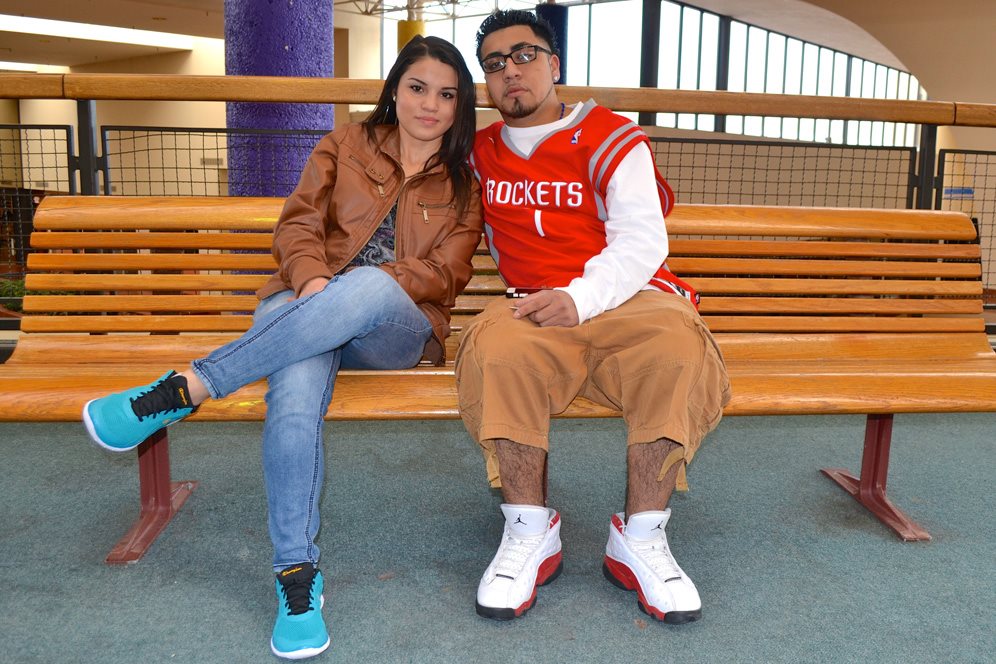 Couple sit on bench at mall