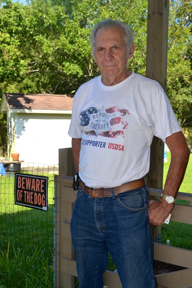 Mechanical engineer stands in his yard