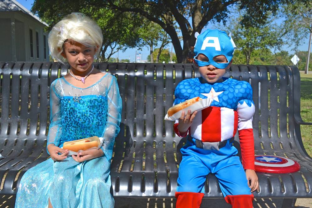 Brother and sister wearing Halloween costumes