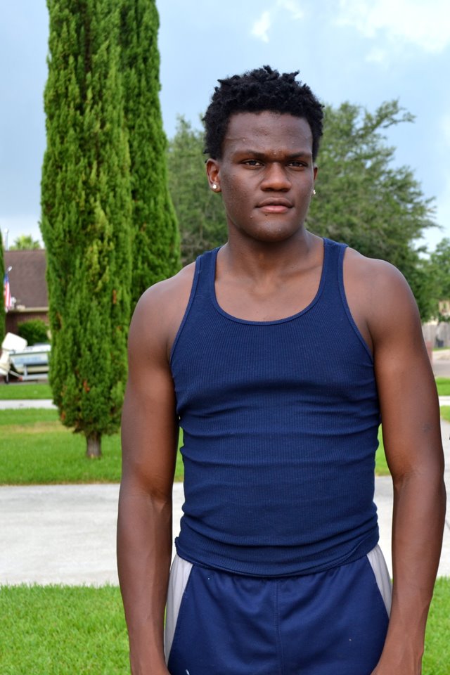 Young man stands in yard