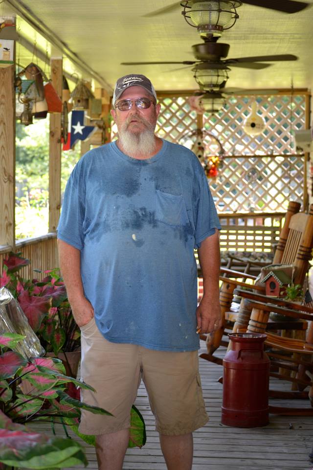 Woodworker stands on back porch