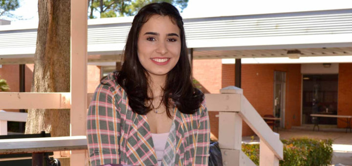 Lorena Moraes sits at table at Lee College