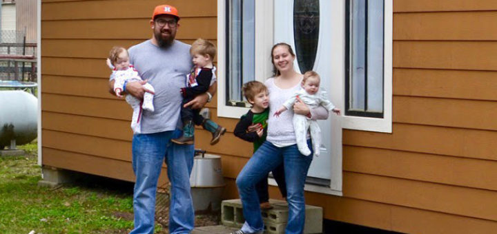 Family in front of their tiny house