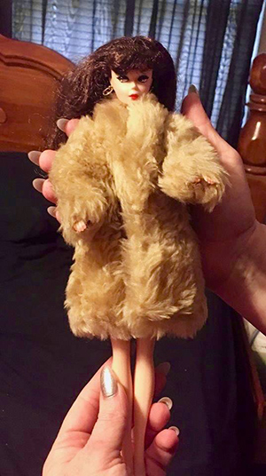 Barbie doll wearing a fur coat