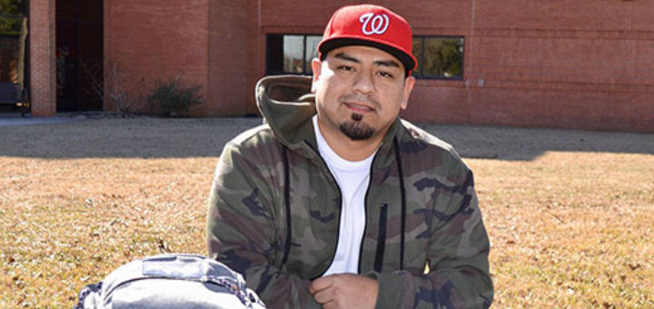 Jerry Rodriguez sits at table on Lee College campus
