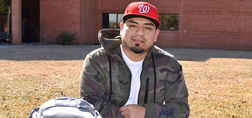 Jerry Rodriguez sits at table on Lee College campus