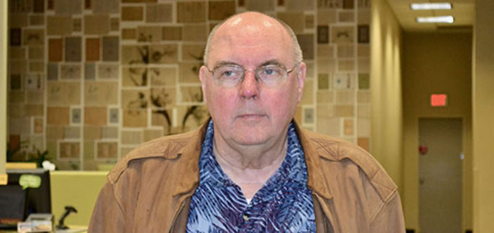 Keith Dick standing in library lobby