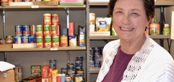 Barbara Wilson with food in her church's pantry