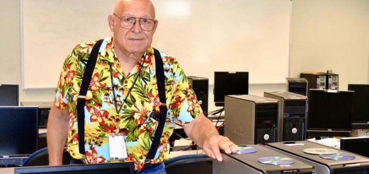 Chuck Ganze standing in a room full of computers