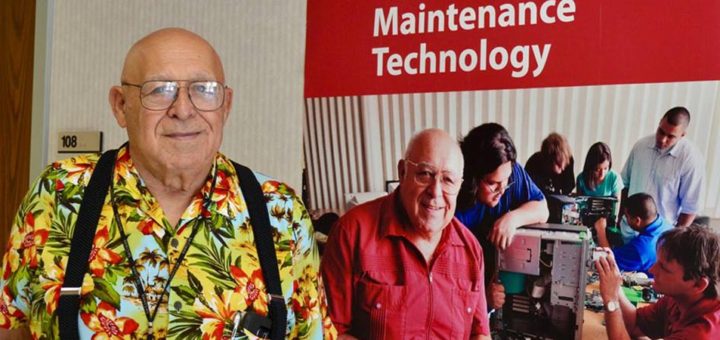 Chuck Ganze stands next to poster at Lee College