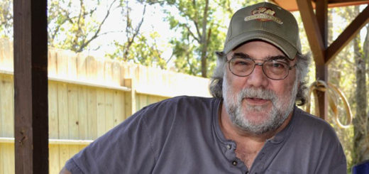 Cliff Duhon sits outside his home