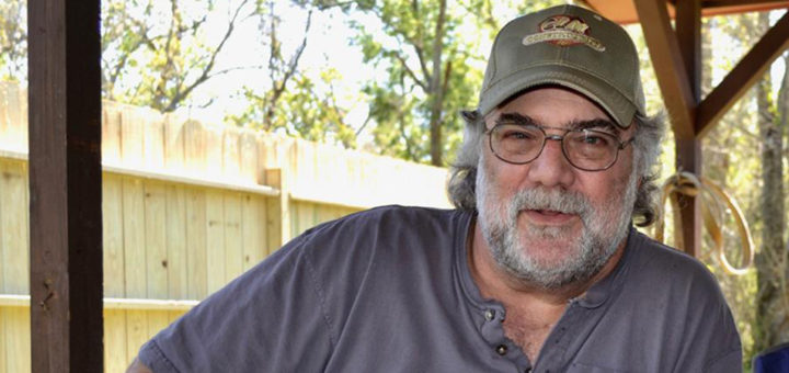 Cliff Duhon sits outside his home