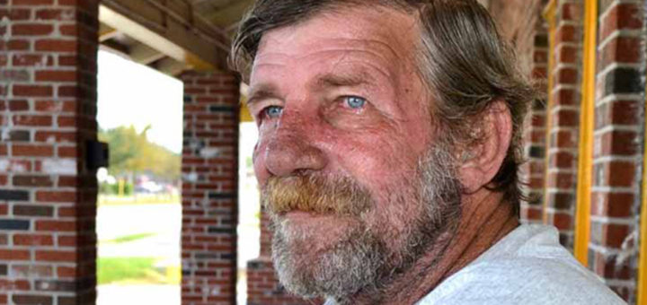 Fred Roach sits outside a restaurant