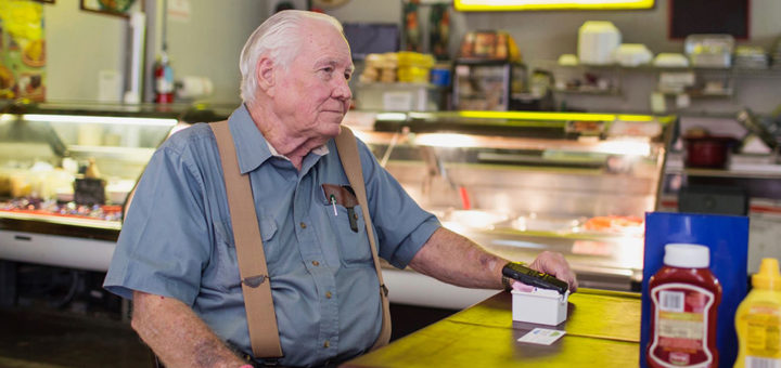 Lowell Cox sitting in his restaurant, Rooster's Steakhouse