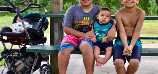Three of Melly Rendon's sons sit at a picnic table