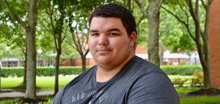 Noel Mallett sitting on bench at Lee College