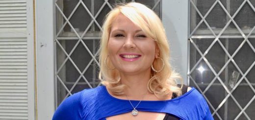 Sarah Graham stands in front of her home