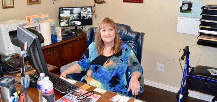 Sherry McKinney sits at her office desk