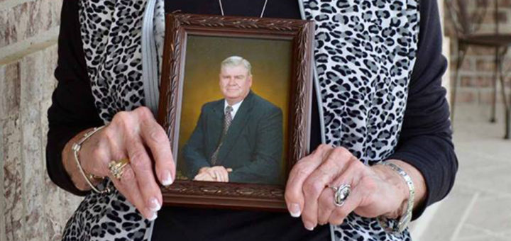 Stella Bird Radle holds a photo of her late husband