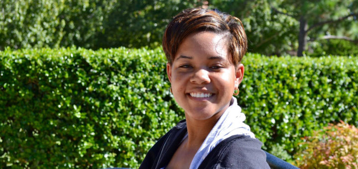 Ahya Speaker sits on a bench at Lee College