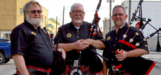 Bagpipe players holding their instruments