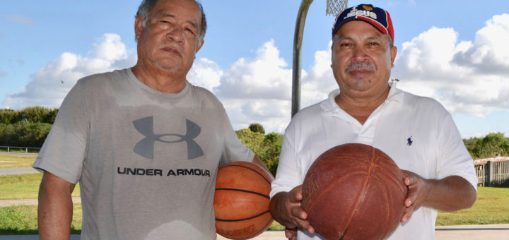 Two men holding basketballs