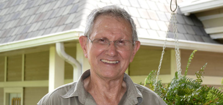 Charlie Fulton stands outside of his house