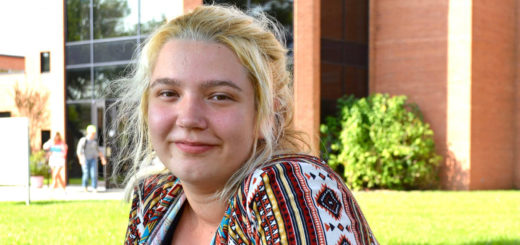 Chloe Anderson sits at a bench on Lee College campus