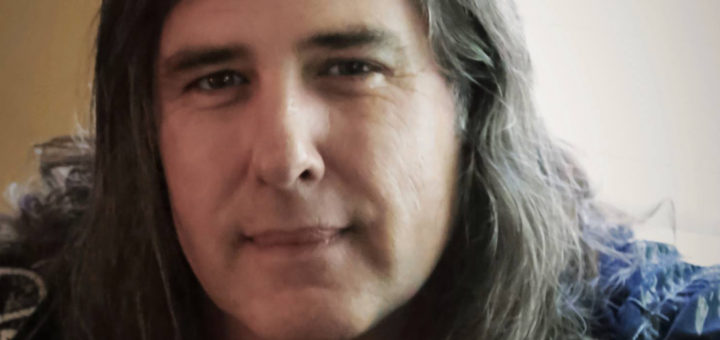 Clint Glaze sitting in his home