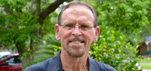 Don Cunningham stands in his yard