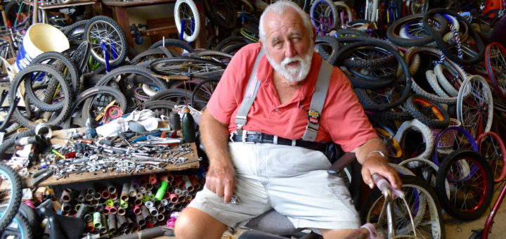 Ken "Fat Mac" Williamson repairs a bike