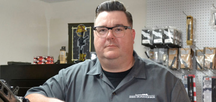 Glenn Slaven stands in gun shop
