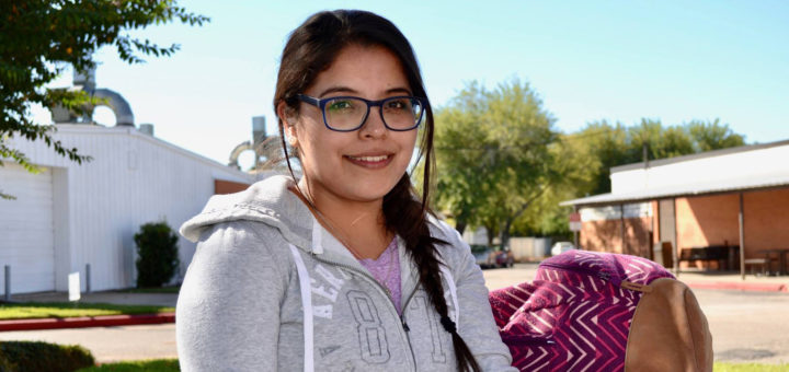 Maria Martinez sits at a table on the Lee College campus