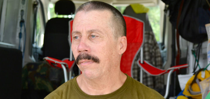 Mike sits in the back of his van