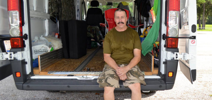 Mike sits in back of his van